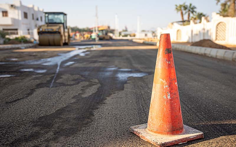 close up orange traffic cone road